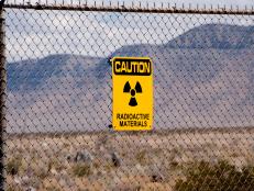 Socorro, New Mexico, USA  - April 2, 2016: Warning signs about radioactive materials were erected at what is now White Sands Missile Range following the detonation of the world's first atomic bomb in a remote area of south central New Mexico. The technology for a nuclear weapon was developed in extreme secrecy in what was known as the Manhattan Project. The test bomb, which was exploded July 16, 1945, proved that the concept would work and led to the dropping of two powerful atomic bombs on Japan -- helping to end World War II. Open houses are conducted free for the general public twice yearly at what is now known as the Trinity Site (ground zero), where photographs of various exhibits are permitted. The Trinity Site located about  35 miles southeast of of Socorro, New Mexico is a National Historic Landmark. 