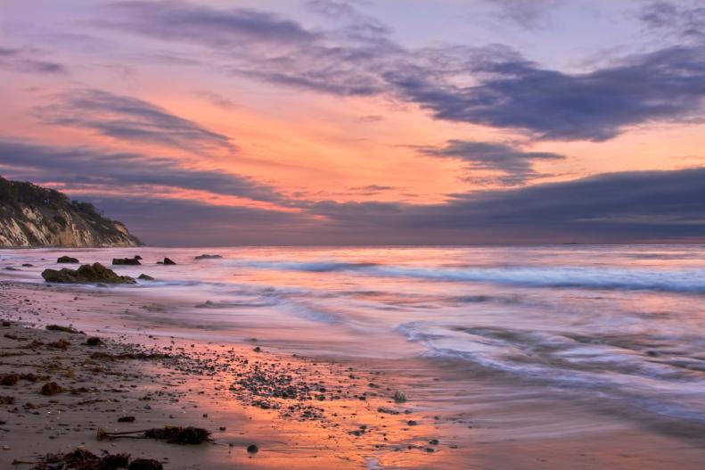 An ocean sunset at low tide in Santa Barbara, California.