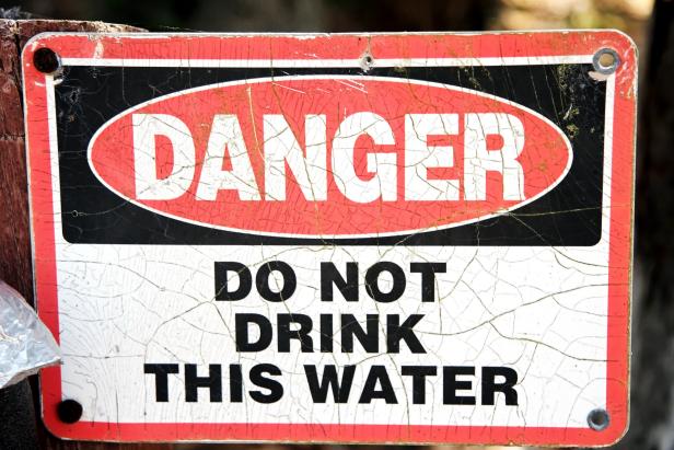 Faded DANGER DO NOT DRINK THIS WATER sign. Horizontal.