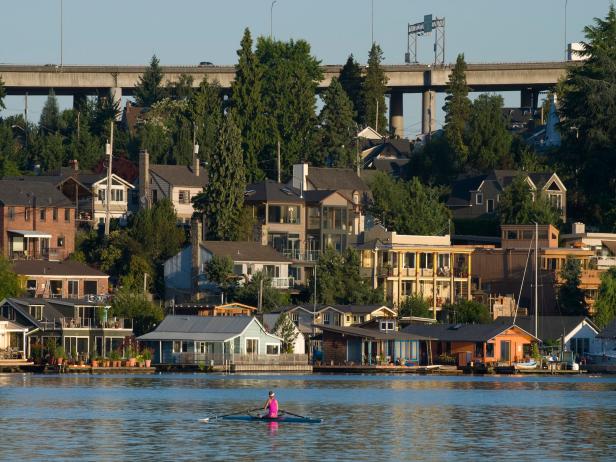Rowboat passing by Seattle houseboats at dawn.Please see more Seattle houseboats from my portfolio: