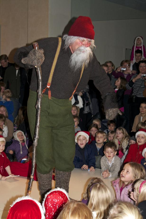 TO GO WITH AFP STORY BY AGNES VALDIMARSDOTTIRStekkjastaur, or Sheep-Cote Clod, Iceland's first Santa of 13, entertains children at the National Museum of Iceland in Reykjavik on December 13, 2010. They don't wear red, and they're not jolly: the 13 Santas who usher in Christmas in Iceland are descendants of trolls and ogres who revel in terrifying young children. A green-clad elf leads around 100 children in a loud caroling chorus as they wait with palpable fear and anticipation for the guest of honour: It is 13 days before Christmas and the first of the Yule Lads is expected. AFP PHOTO /AGNES VALDIMARSDOTTIR (Photo credit should read AGNES VALDIMARSDOTTIR/AFP via Getty Images)