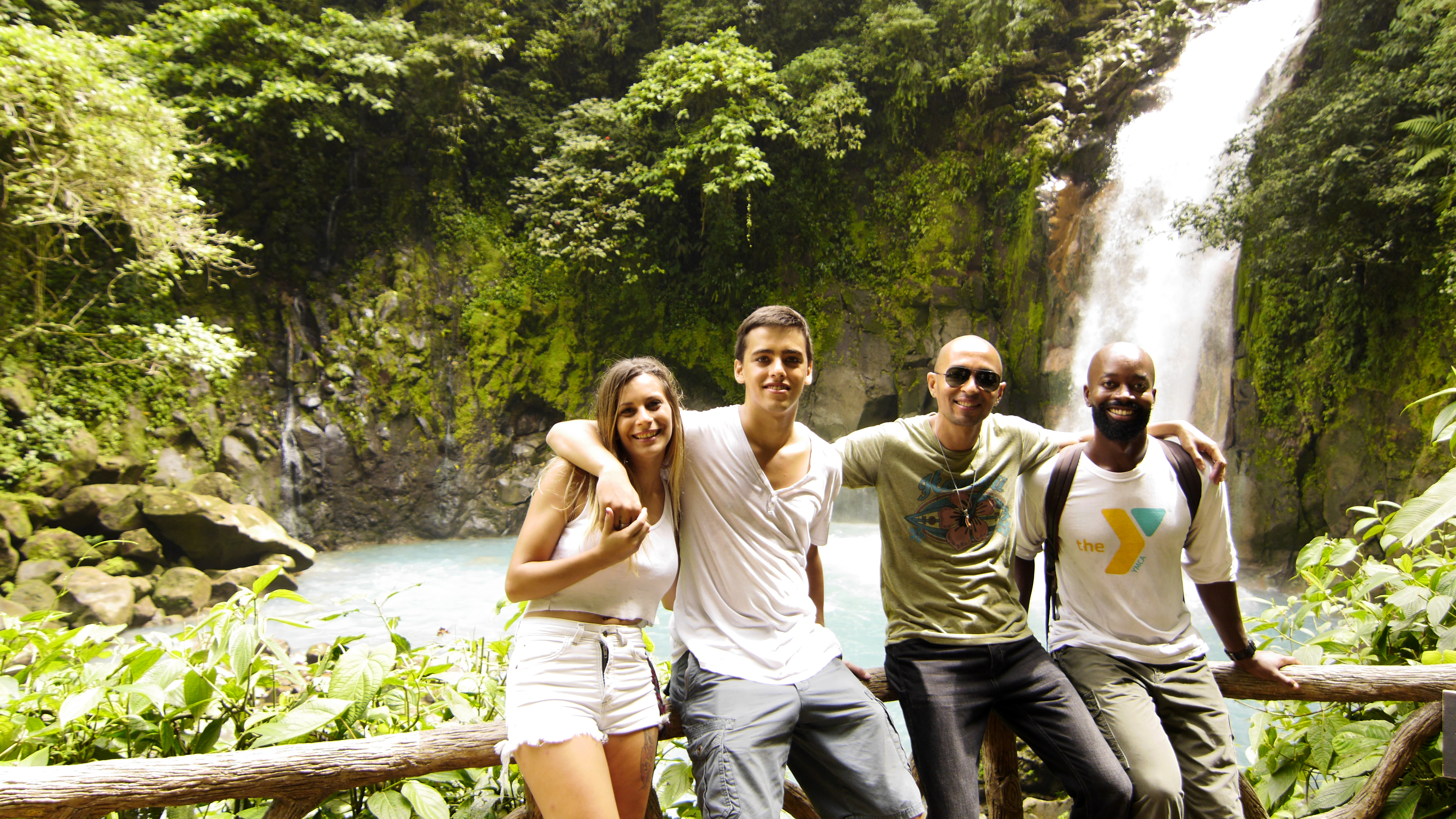 Belen Lois, Federico Suriani, Alejandro Plata, and Eli Lucas posing next to Rio Celesete Waterfall in Catarata de Rio Celeste, Costa Rica as seen on Travel Channel's Top Secret Waterfalls episode TTWF101H.