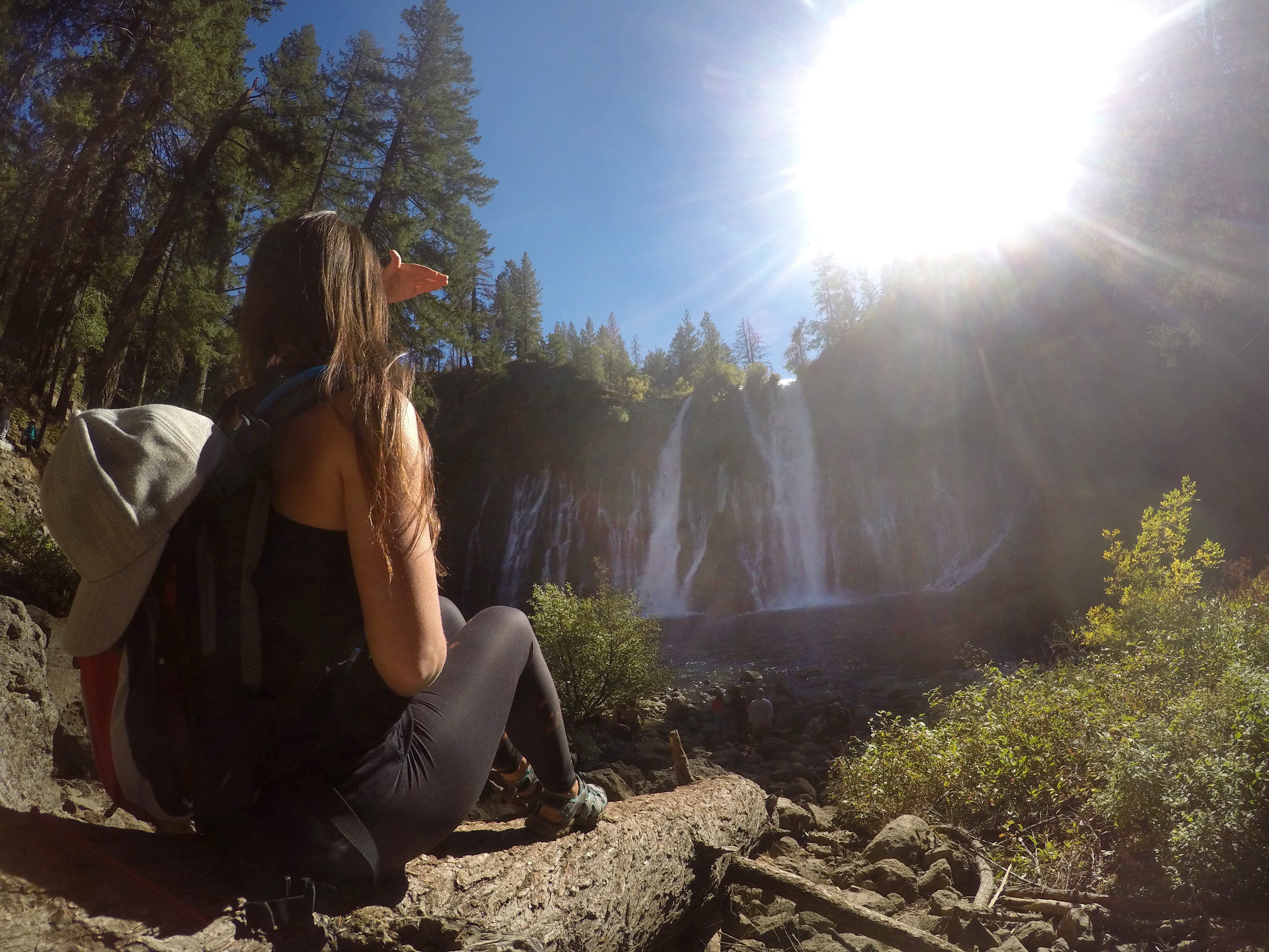 Angela Latham admiring Burney Falls from shore in Burney, California as seen on Travel Channel's Top Secret Waterfalls episode TTWF101H.