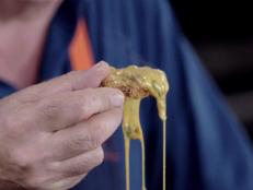 Make Andrew Zimmern's cornmeal cakes with a spicy chile cheese dip, inspired by his travels in Texas for Bizarre Foods.